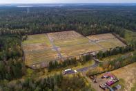 An aerial view shows fresh graves at the Yastrebkovskoe cemetery, which serves as one of the burial grounds for those who died of the coronavirus, outside in Moscow, Russia, Thursday, Oct. 21, 2021. The government coronavirus task force reported 36,339 new confirmed infections and more than thousand deaths in the past 24 hours. That brought Russia's death toll to 227,389, by far the highest in Europe. Moscow Mayor Sergei said all restaurants, cafes and non-food stores, gyms, cinemas and other entertainment venues in the Russian capital will be shut from Oct. 28 to Nov. 7. (AP Photo/Dmitry Serebryakov)