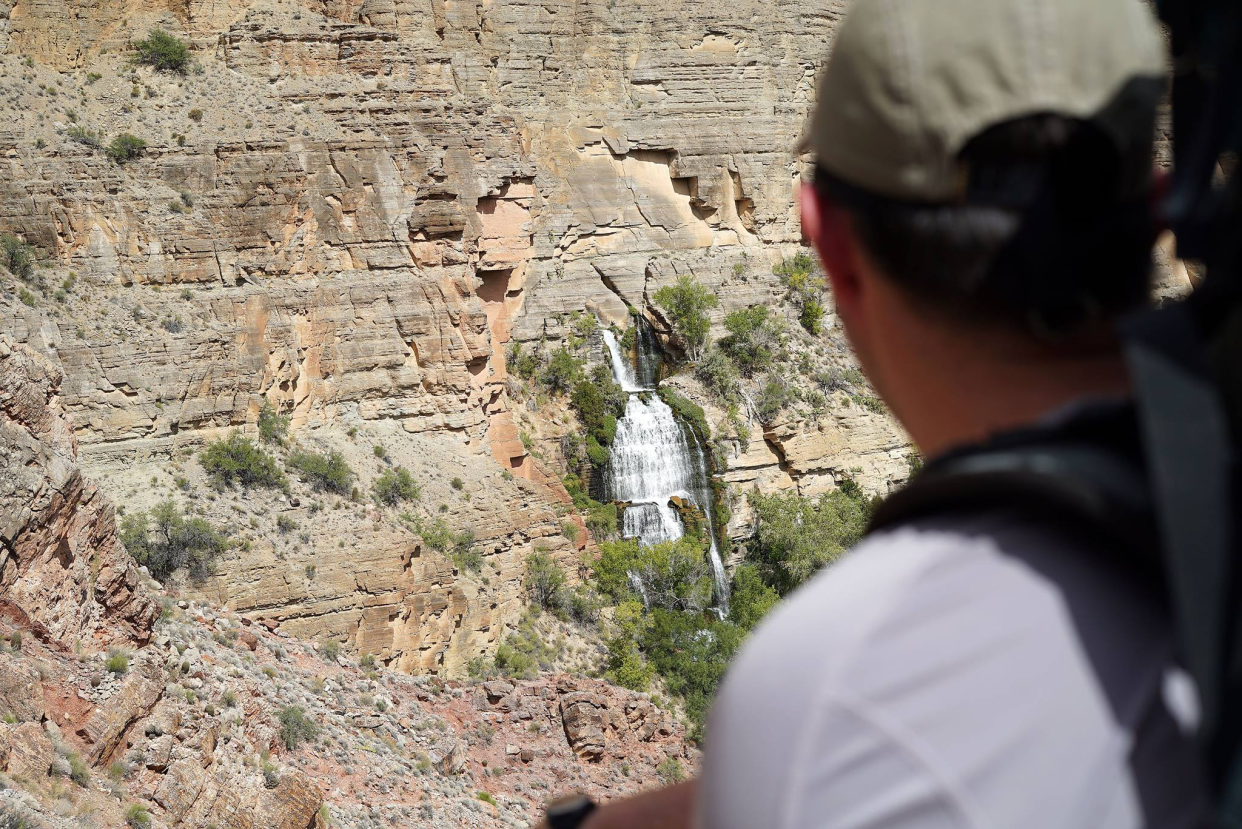 A backpacker looks at Thunder River emerging from a rock wall on Grand Canyon's North Rim in this October 2017 file photo.