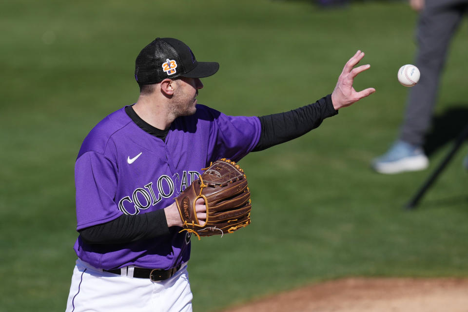 Colorado Rockies pitcher Ty Blach reaches out to catch a baseball during the first day of spring training baseball workouts for Rockies pitchers and catchers in Scottsdale, Ariz., Wednesday, Feb. 15, 2023. (AP Photo/Ross D. Franklin)