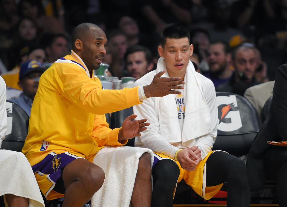 FILE - In this Wednesday, Nov. 26, 2014 file photo, Los Angeles Lakers guard Kobe Bryant, left, talks with guard Jeremy Lin during the first half of an NBA basketball game against the Memphis Grizzlies in Los Angeles. For the G League Ignite, it was a beginning. For Jeremy Lin, it may be a new beginning. He’s one of the former NBA players in the G League bubble at Walt Disney World in Lake Buena Vista, Florida this month, as part of the Santa Cruz Warriors. (AP Photo/Mark J. Terrill, File)