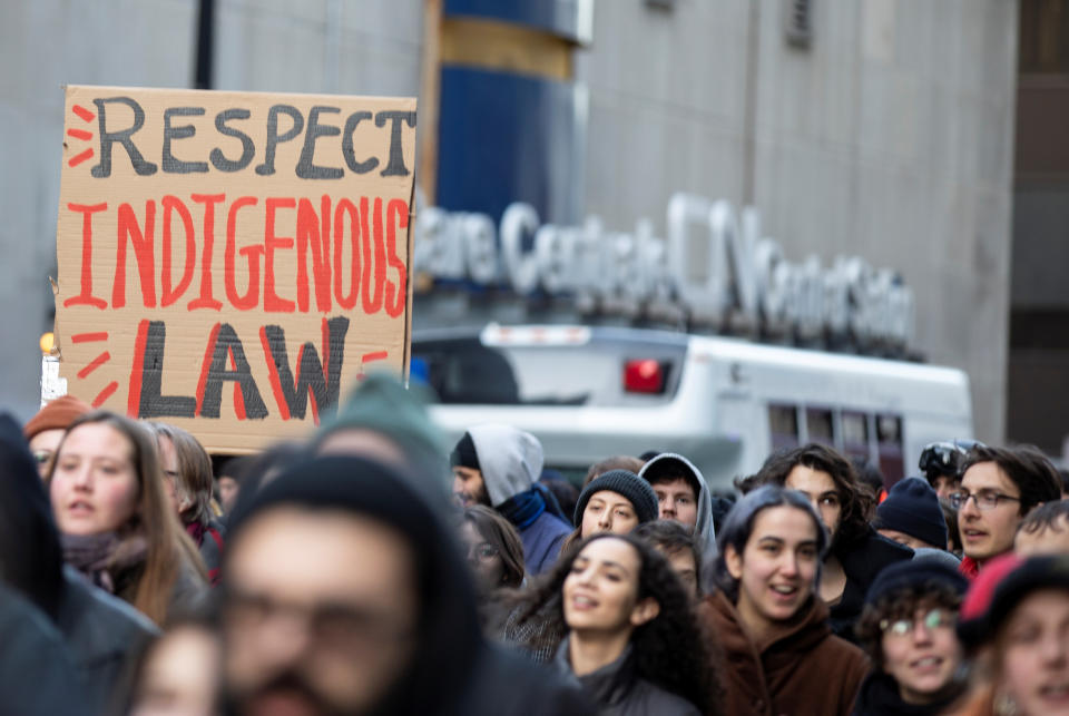 Supporters of the indigenous Wet'suwet'en Nation's hereditary chiefs pass by CN Rail as they march as part of protests against British Columbia's Coastal GasLink pipeline, in Montreal, Quebec, Canada February 25, 2020.  REUTERS/Christinne Muschi