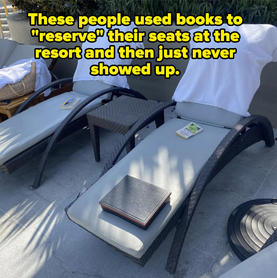 Two empty poolside lounge chairs each with a towel draped over the backrest. One chair has a book, and the other has a tablet