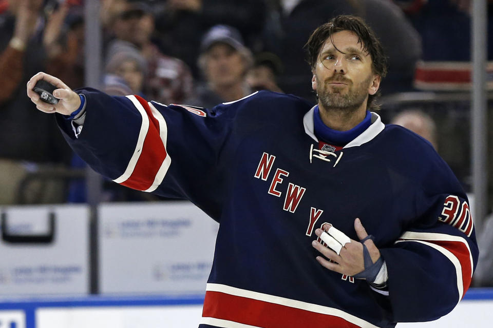 FILE - In this Feb. 11, 2017, file photo, New York Rangers goalie Henrik Lundqvist celebrates his 400th career win, after an NHL hockey game against the Colorado Avalanche, in New York. The New York Rangers have bought out the contract of star goaltender Henrik Lundqvist. The Rangers parted with one of the greatest netminders in franchise history on Wednesday, Sept. 30, 2020, when they paid off the final year of his contract. (AP Photo/Adam Hunger, File)