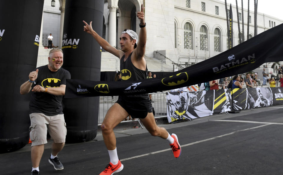 Dan Nestor of Colorado wins the Batman Inaugural 5K run on Batman's 80th anniversary at Grand Park on Saturday, Sept. 21, 2019, in Los Angeles. (Keith Birmingham/The Orange County Register via AP)