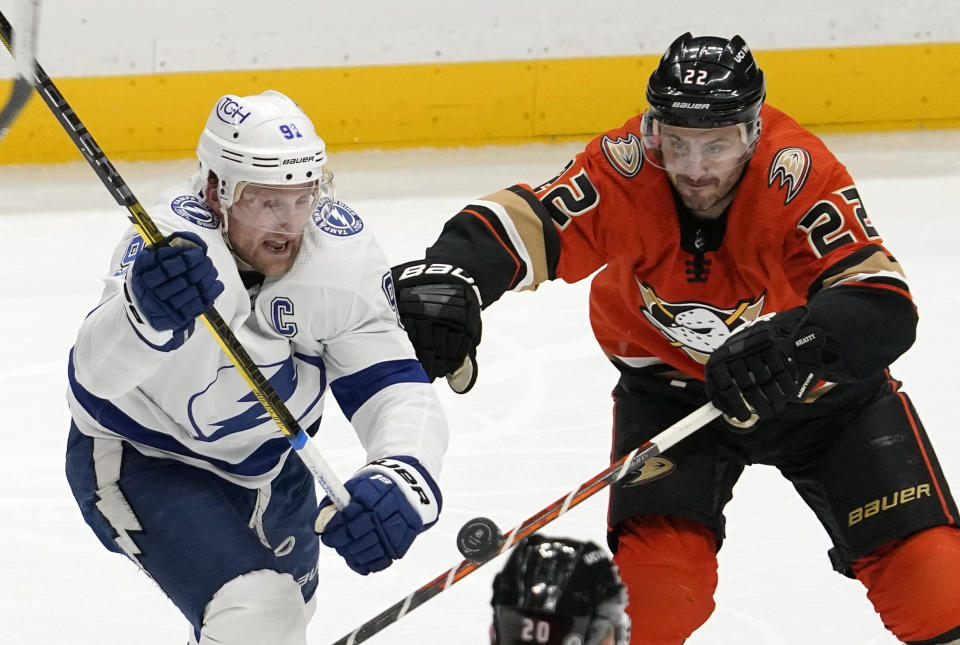 Tampa Bay Lightning center Steven Stamkos, left, and Anaheim Ducks defenseman Kevin Shattenkirk vie for the puck during the second period of an NHL hockey game Friday, Jan. 21, 2022, in Anaheim, Calif. (AP Photo/Mark J. Terrill)