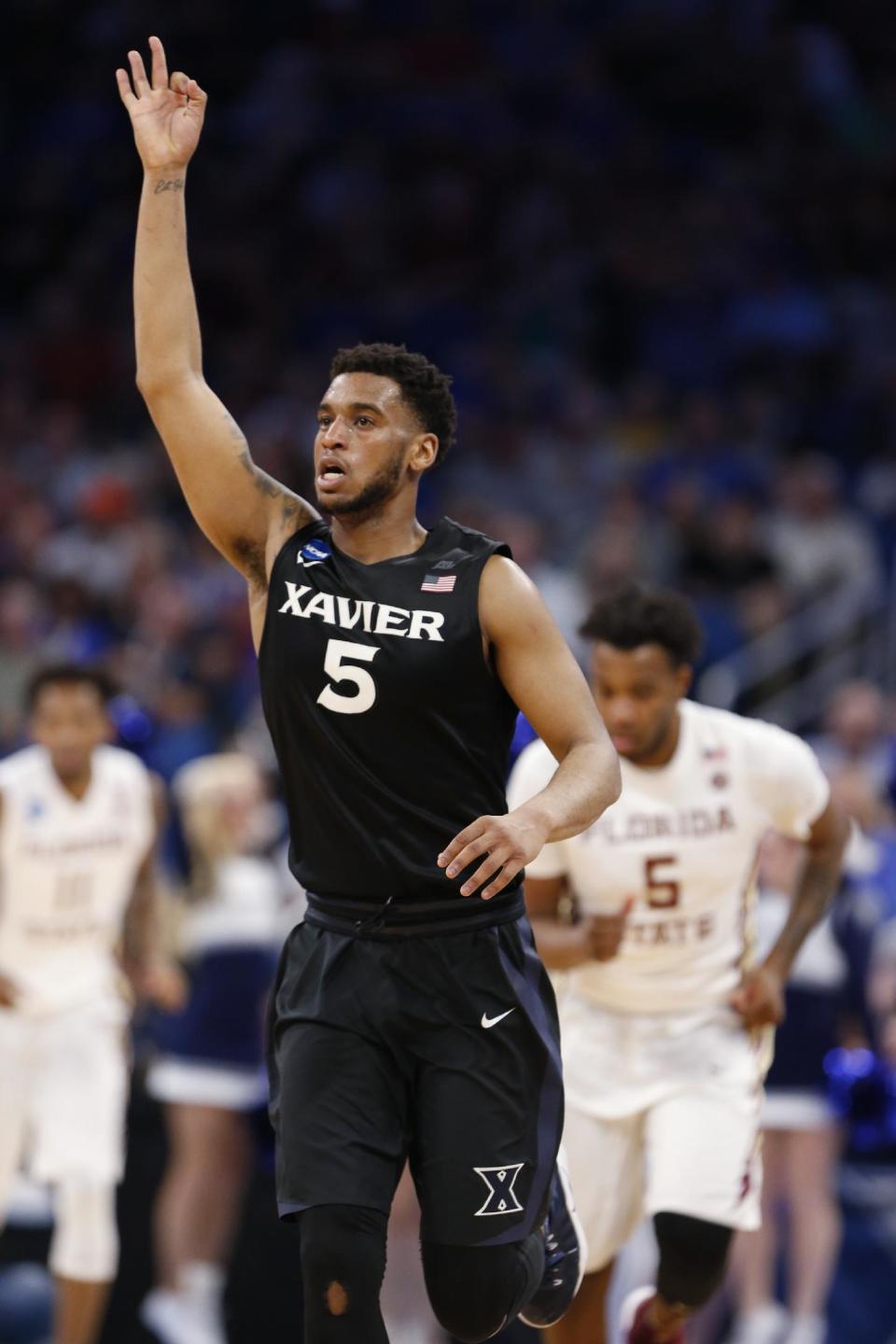 Xavier guard Trevon Bluiett (5) celebrates a 3-point shot during the second half against Florida State in the second round of the NCAA men's college basketball tournament, Saturday, March 18, 2017 in Orlando, Fla. Xavier defeated Florida State 91-66. (AP Photo/Wilfredo Lee)