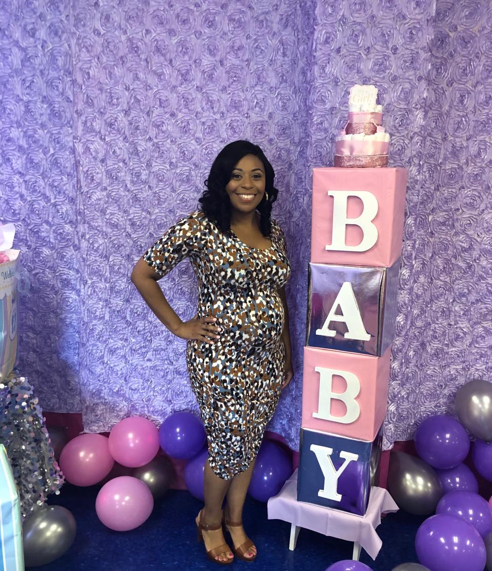 A pregnant Dr. Chaniece Wallace poses for a photo.