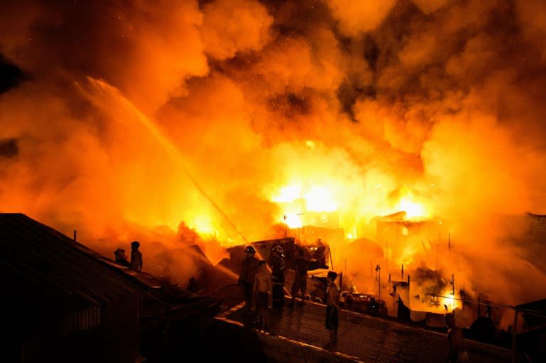 Firefighters battle the fire in Delpan, Tondo, Manila on February 7, 2017