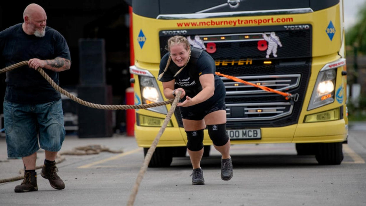 Vikki Mills achieved her weight loss through changing her diet, taking up weight training and having counselling, pictured here competing in a truck-tugging contest. (SWNS)