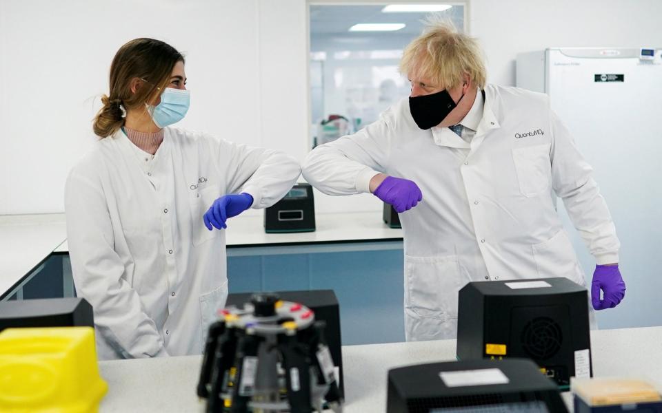 Britain's Prime Minister Boris Johnson elbow bumps a person as he visits the QuantuMDx Biotechnology company during a visit to the company in Newcastle - Ian Forsyth/Pool via REUTERS