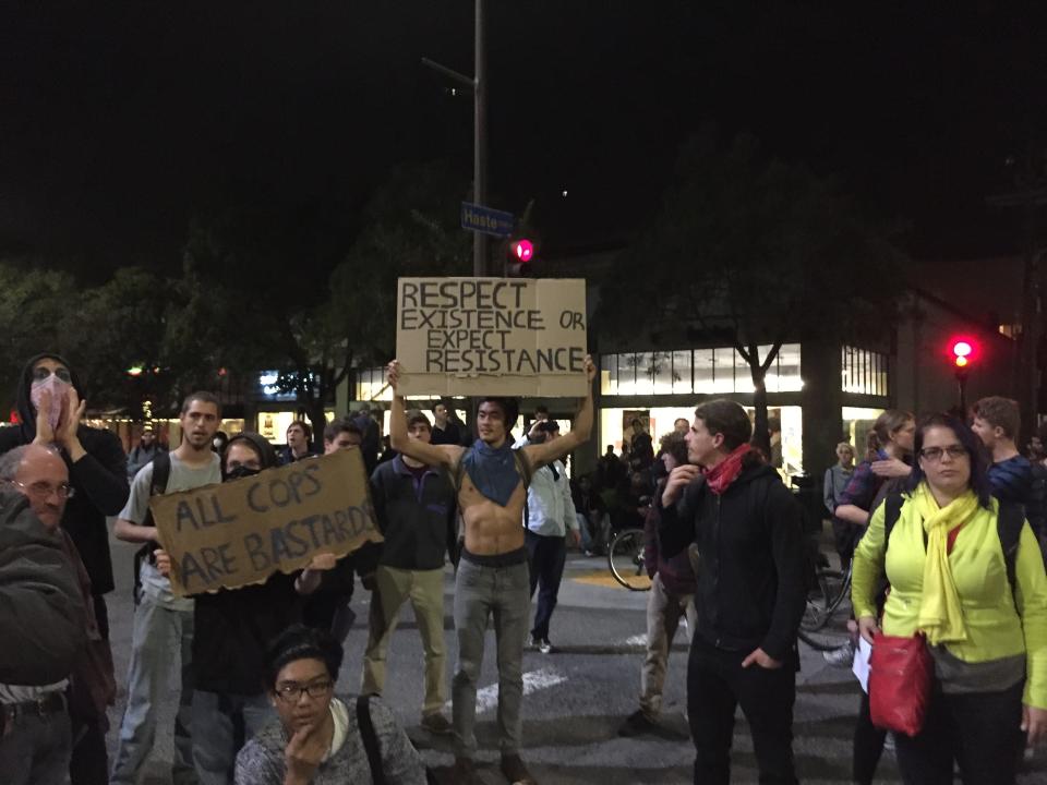 Protester holds up a sign during march in downtown Berkeley