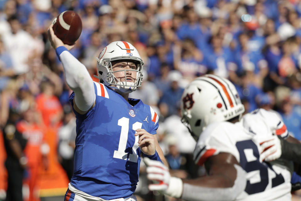 Florida quarterback Kyle Trask (11) throws a pass over Auburn defensive end Nick Coe (91) during the first half of an NCAA college football game, Saturday, Oct. 5, 2019, in Gainesville, Fla. (AP Photo/John Raoux)