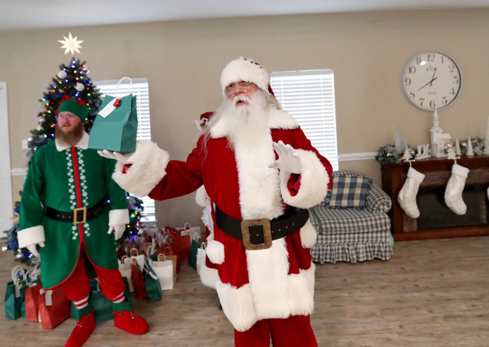 Santa is joined by Jingles the Elf as they present gifts during a senior luncheon on Thursday, December 8, 2023 at Powers Baptist Church in Eden, Georgia.