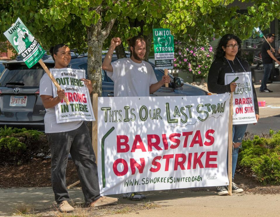 Baristas Mbake Sarr, left, Scott Derosier, and Johanny Garcia picket Monday in front of the East Central Street Starbucks in Worcester.