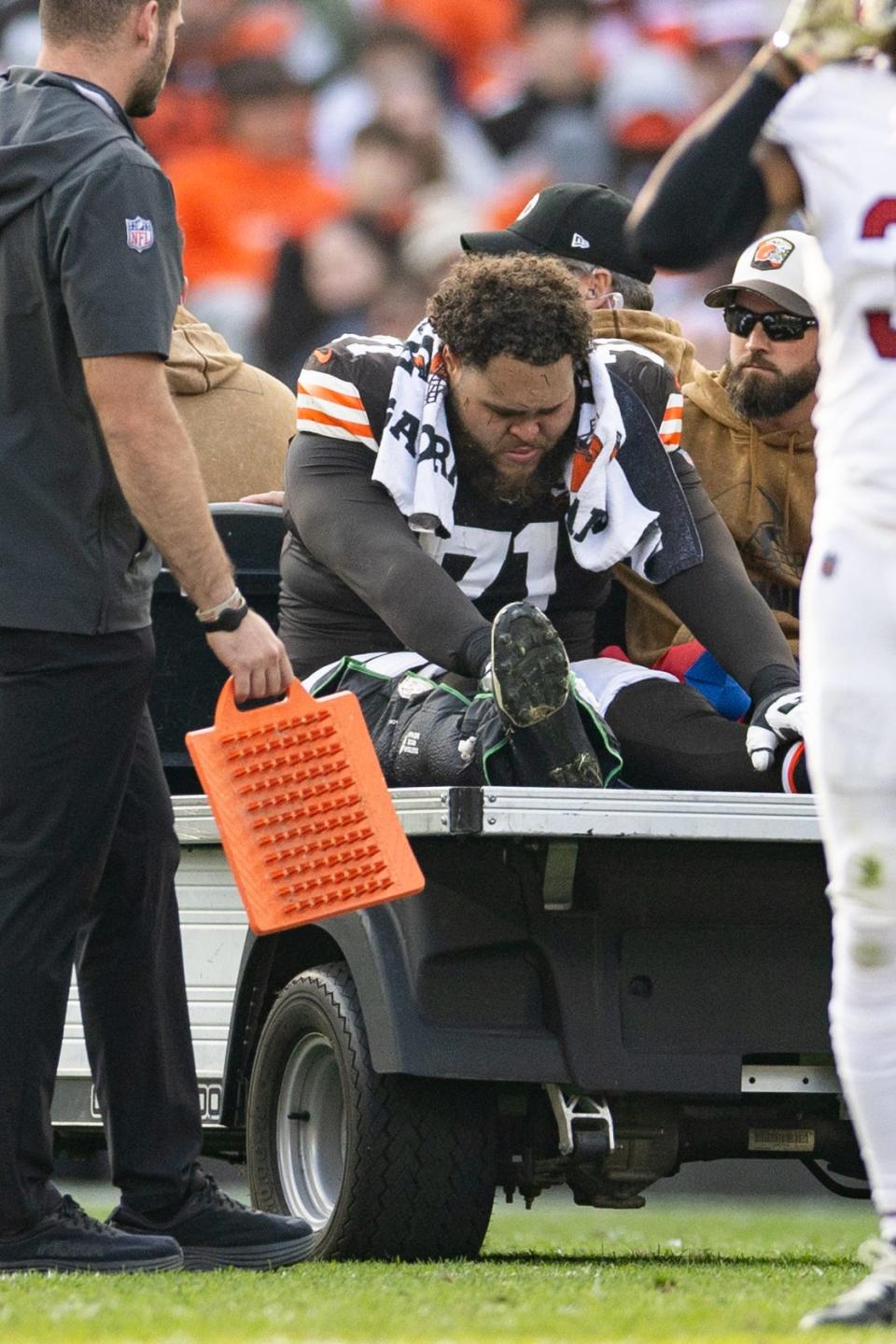 Cleveland Browns offensive tackle Jedrick Wills Jr. (71) leans over as he is carted off the field after an injury during the third quarter Sunday against the Arizona Cardinals in Cleveland.