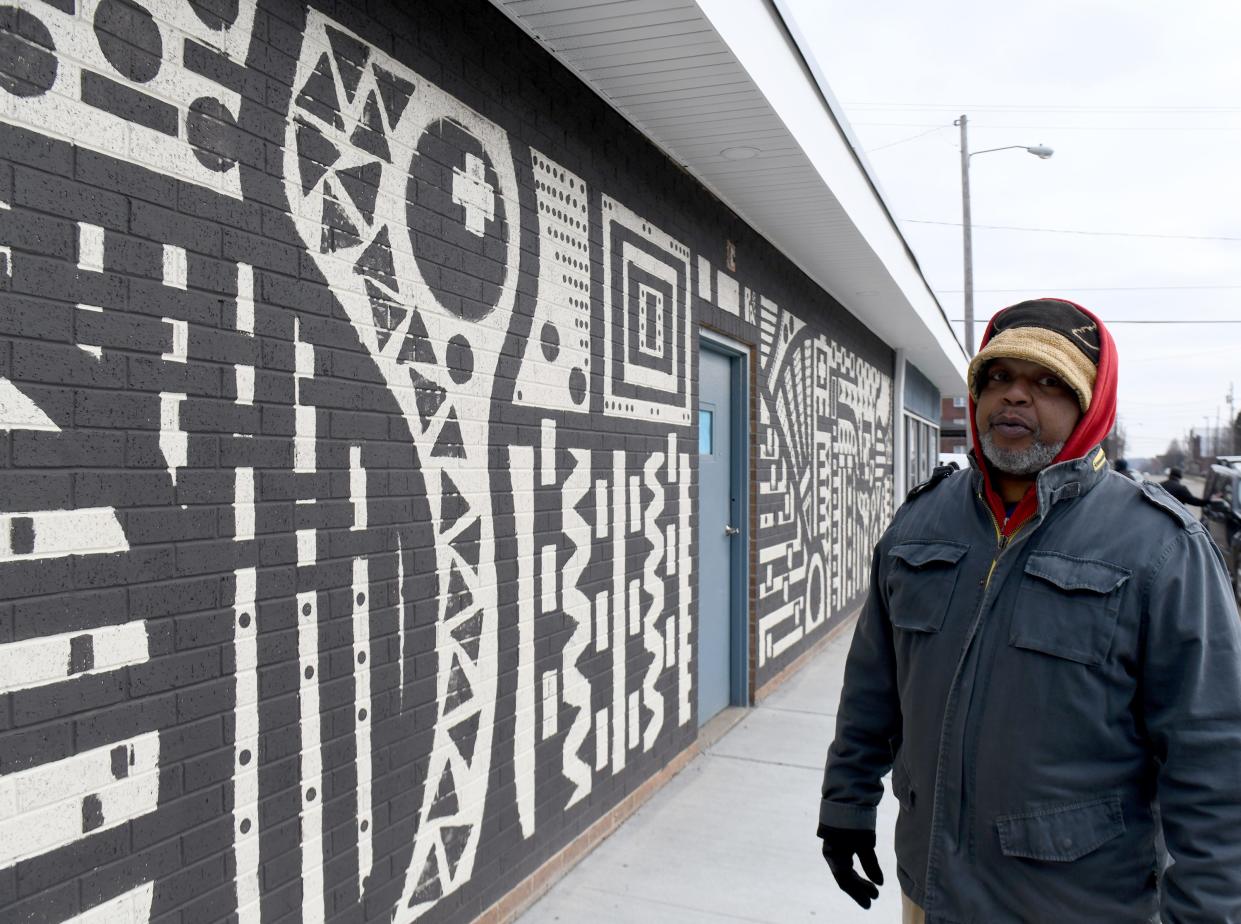 Artist Errick Freeman is creating a "hospitality" mural on the exterior of the Shorb Neighborhood Market and Connection Center at Sixth Street and Shorb Avenue NW in Canton. Many of the neighborhood's residents are immigrants.