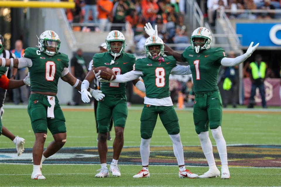 Left to right: Florida A&M linebacker Isaiah Major and defensive backs Javan Morgan, Eric Smith, and Lovie Jenkins celebrate Smith's interception versus the Bethune-Cookman Wildcats at the Florida Blue Florida Classic at Camping World Stadium in Orlando, Florida, Saturday, Nov. 19, 2023.