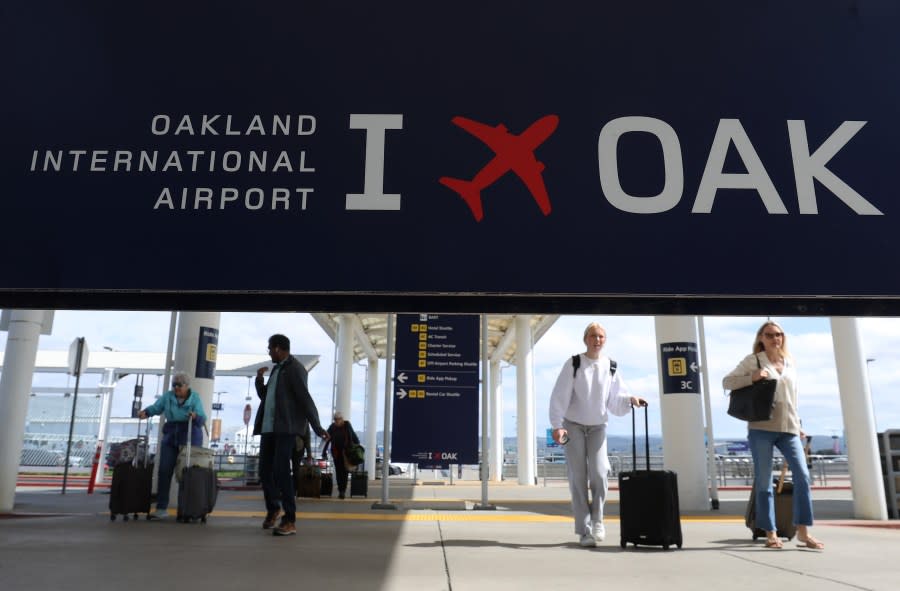 Travelers walk towards Terminal 2 at Oakland International Airport on April 12, 2024 in Oakland. (Photo by Justin Sullivan/Getty Images)