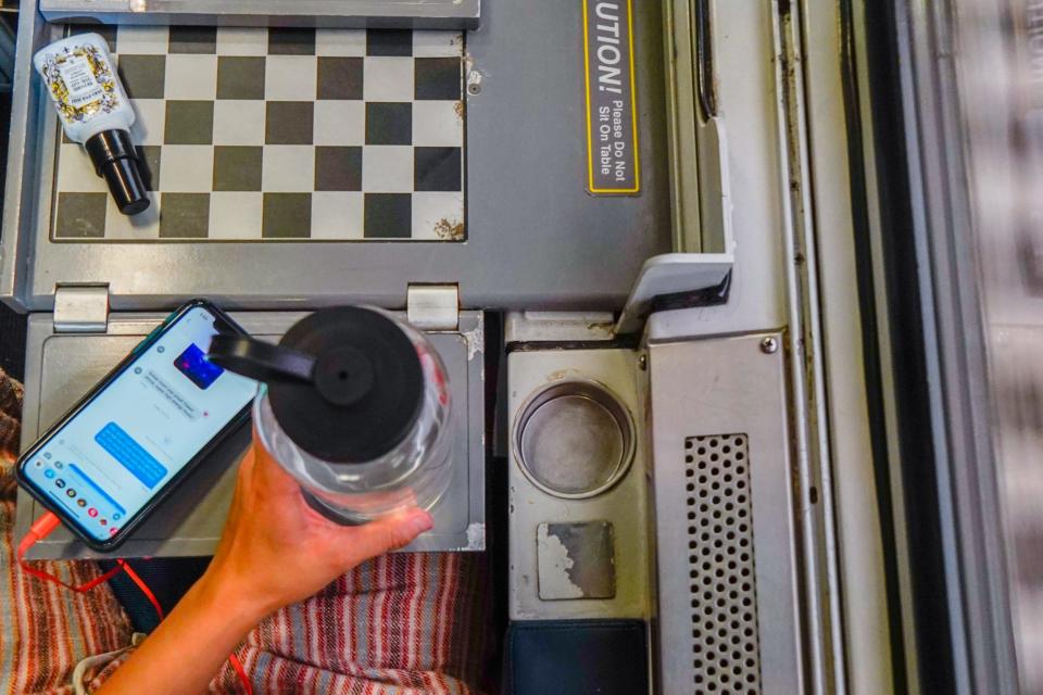 The authors water bottle is seen next to a cup holder that's too small