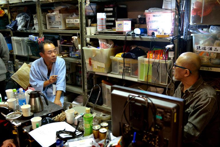 Japanese adult video (AV) director Tohjiro (R) speaking to porn actor Ginji Sagawa at a studio in Tokyo