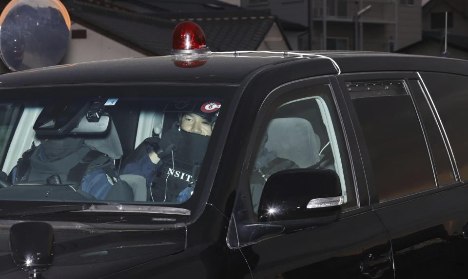 A vehicle carrying a suspect, unseen, arrives at a police station in Nakano, Nagano prefecture, central Japan Friday morning, May 26, 2023. Japanese police captured the suspect with a rifle and knife who had holed up inside a house after killing four people, including two police officers, was arrested early Friday after an hourslong standoff, according to news reports. (Kyodo News via AP)