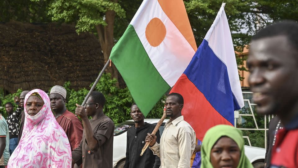 Supporters of Niger's National Council for Safeguard of the Homeland (CNSP) hold up Niger's national flag and the national flag of Russia at the General Seyni Kountche stadium in Niamey on Agust 26, 2023. - AFP/Getty Images