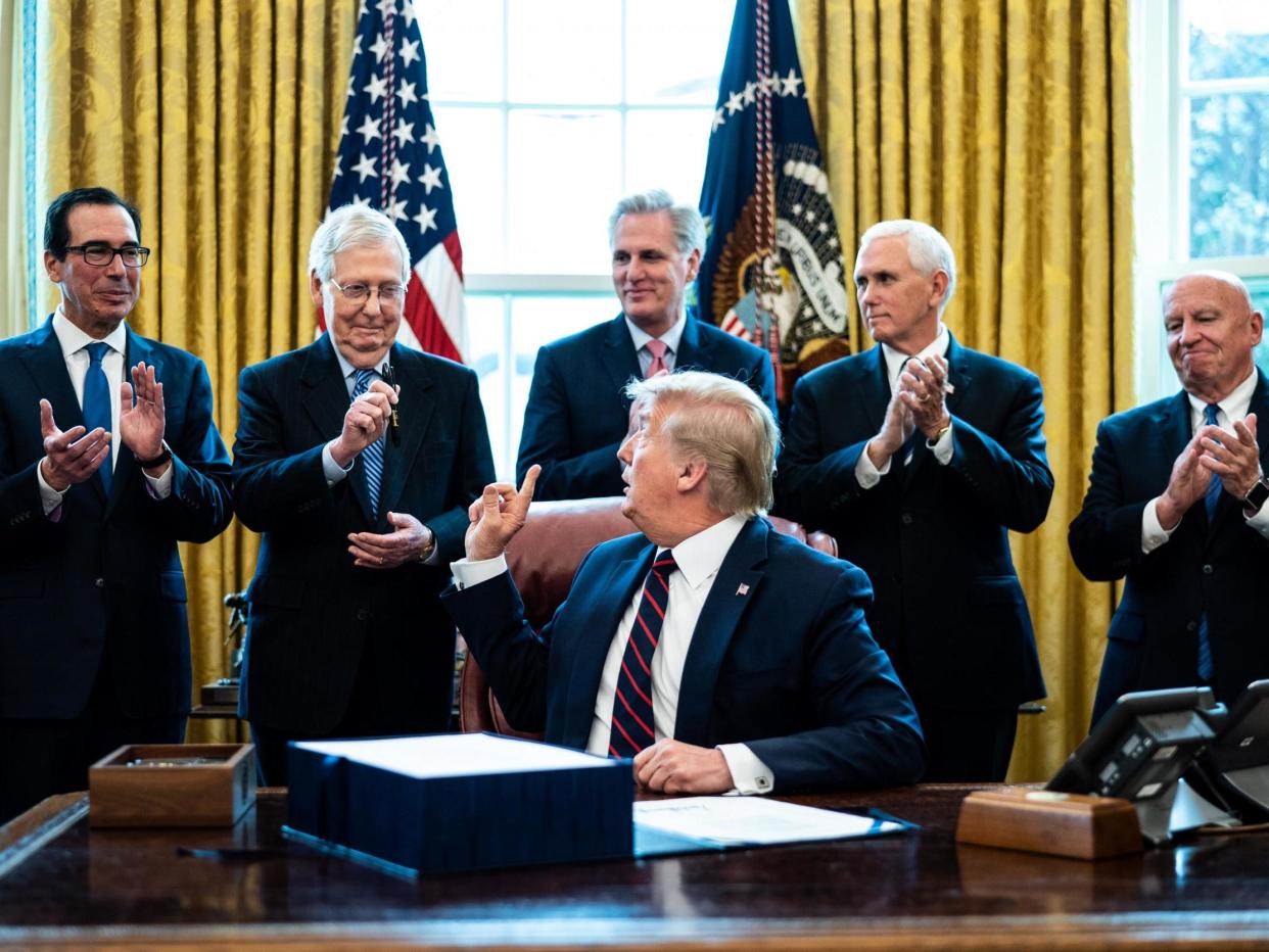 President Donald Trump signs the stimulus bill: Erin Schaff / The New York Times POOL