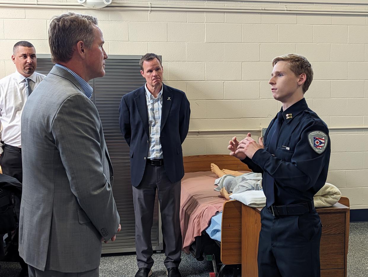 Lt. Gov. Jon Husted, left front, visited the Fremont campus of the Vanguard Sentinel Career and Technology Center on Wednesday. He talks Zach McDaniels, as student in the criminal justice and EMT programs. Vanguard Superintendent Greg Edinger, center, looks on.