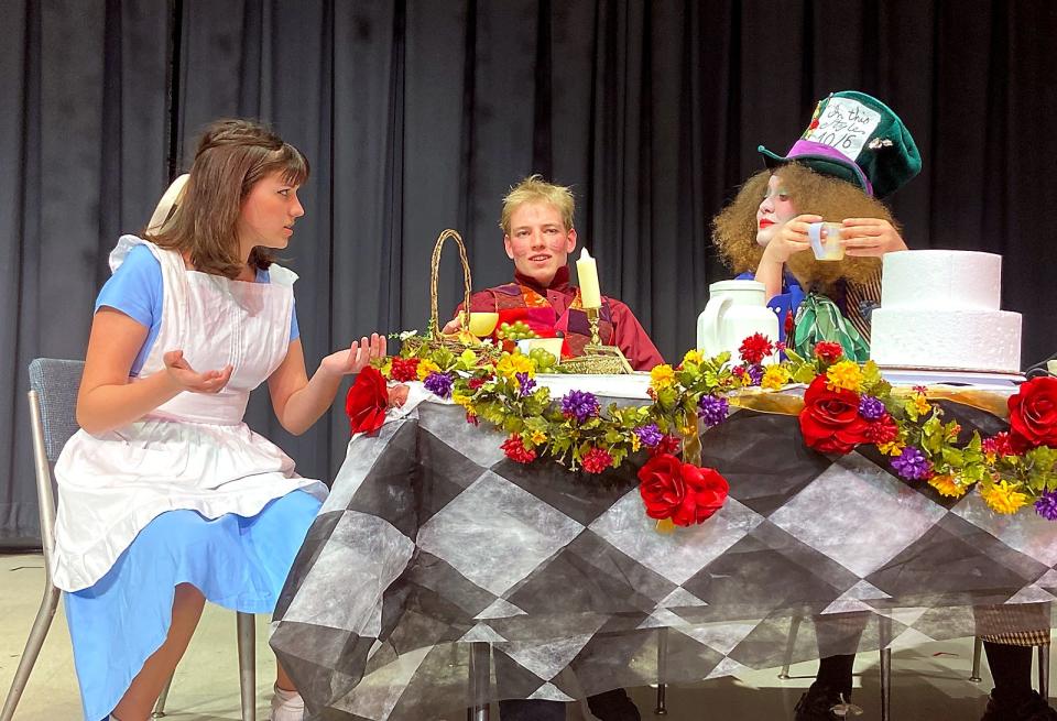 Olivia Happel (Alice), Max Scheske (March Hare) and Mary Butler (Mad Hatter) rehearse a tea party scene in “Alice in Wonderland.”