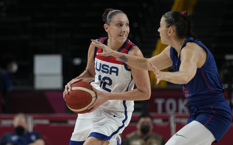 United States' Diana Taurasi (12) drives around Serbia's Sasa Cado (6) during women's basketball semifinal game at the 2020 Summer Olympics, Friday, Aug. 6, 2021, in Saitama, Japan. (AP Photo/Eric Gay)