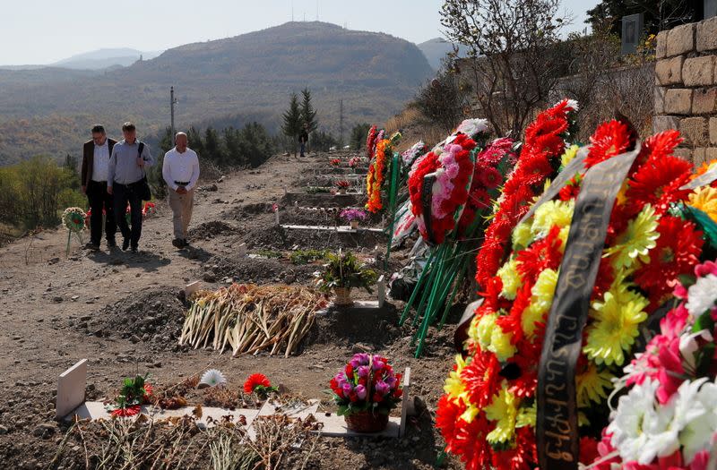 German lawmakers visit a cemetery where soldiers killed during the military conflict over the breakaway region of Nagorno-Karabakh are buried, in Stepanakert