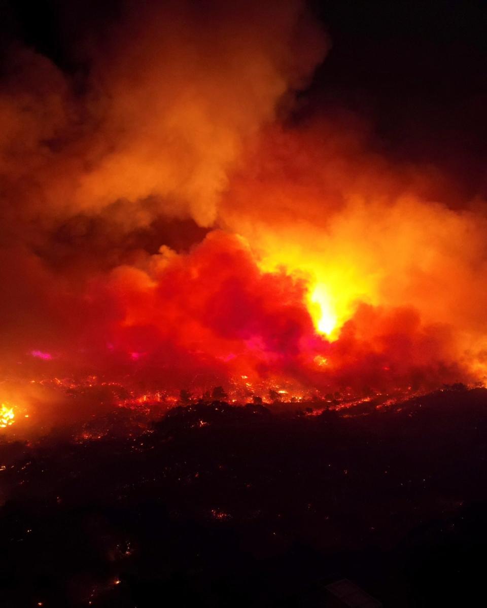 Smoke rises from a wildfire on the island of Rhodes on Sunday (TED G. BAILOS via REUTERS)