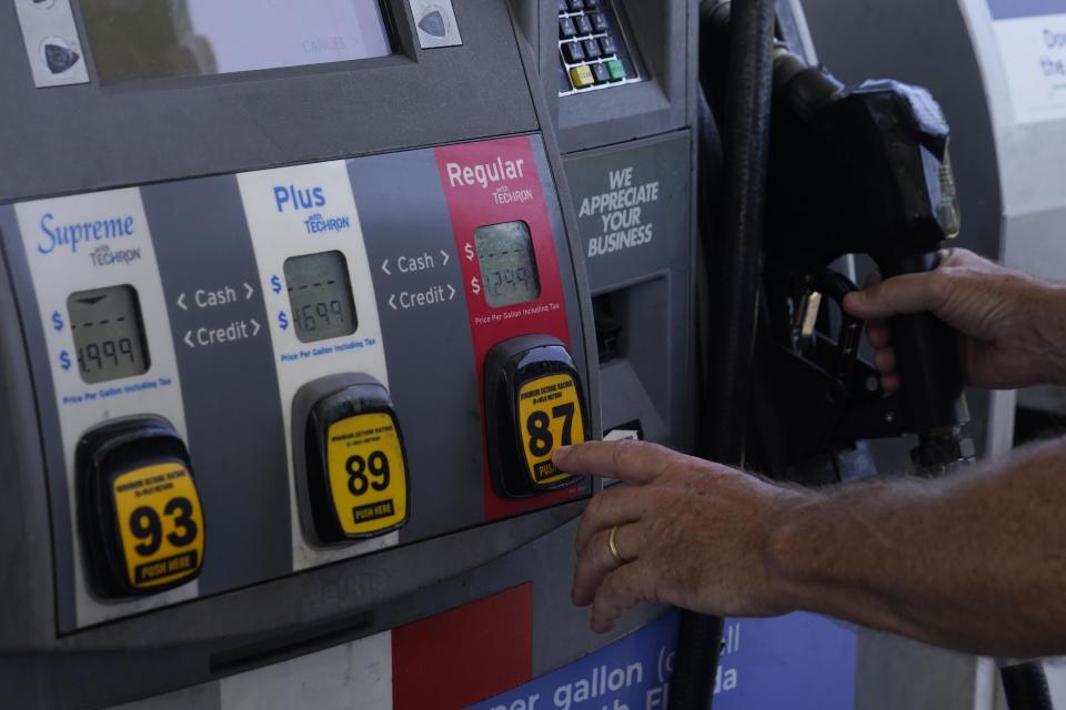 A customer pumps gas at an Exxon gas station, Tuesday, May 10, 2022, in Miami. Gasoline prices are sliding back toward the $4 mark for the first time in more than five months — good news for consumers who are struggling with high prices for many other essentials. (AP Photo/Marta Lavandier)