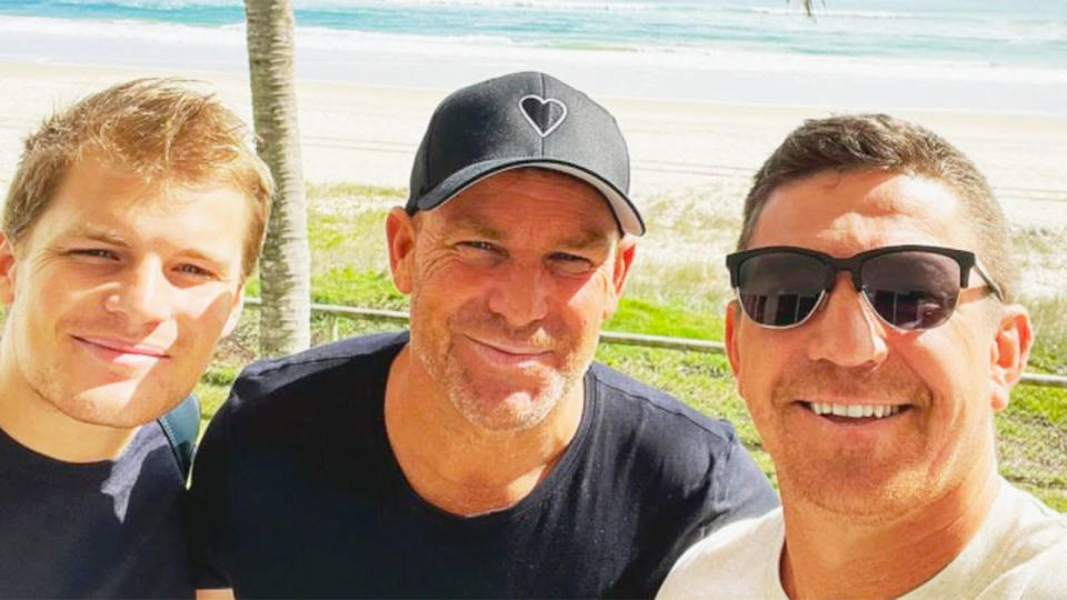 Shane Warne is seen here hanging out with friends at the beach.