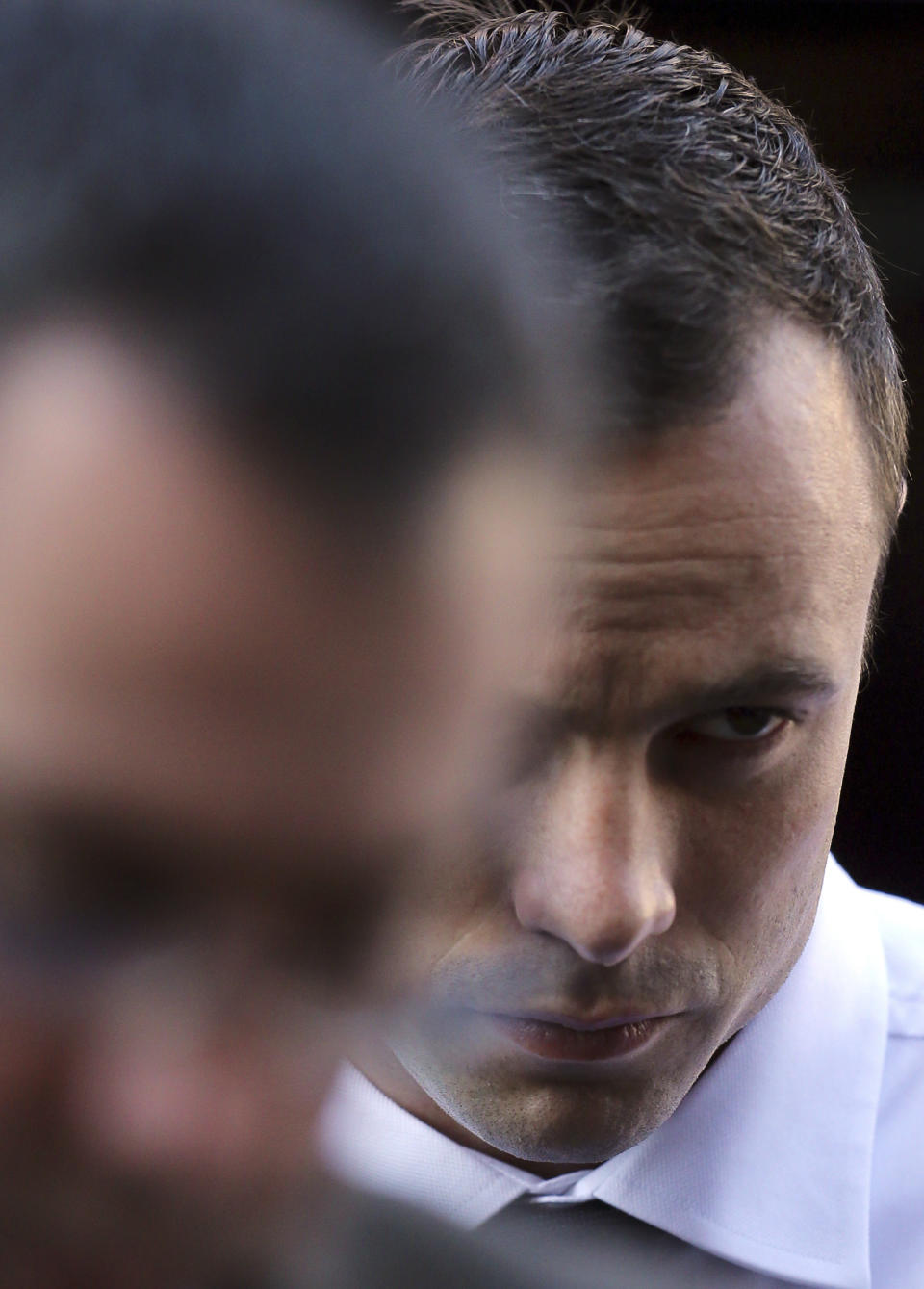 Oscar Pistorius arrives at the high court in Pretoria, South Africa, Friday, April 11, 2014. The chief prosecutor laughed scornfully at an answer from Pistorius during the Olympic athlete's murder trial Thursday, mocking the man who shot his girlfriend. Pistorius is charged with murder for the shooting death of his girlfriend, Reeva Steenkamp, on Valentine's Day in 2013. (AP Photo/Themba Hadebe)