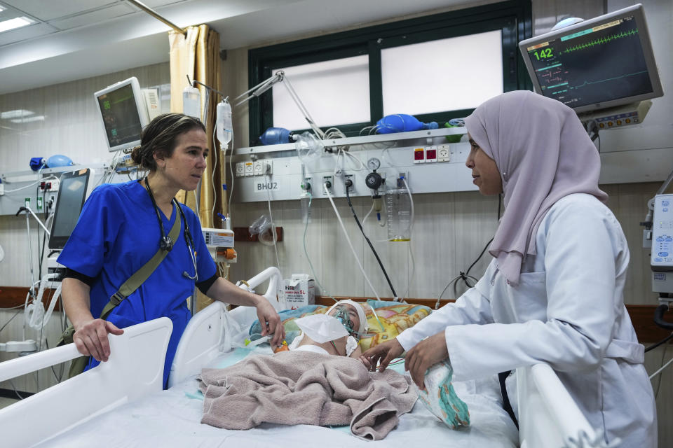 La pediatra Tanya Haj-Hassan (izquierda), examina a un niño herido, en el hospital Mártires de Al-Aqsa, en Deir al-Balah, Gaza, el 16 de marzo de 2024. (AP Foto/Abdel Kareem Hana)