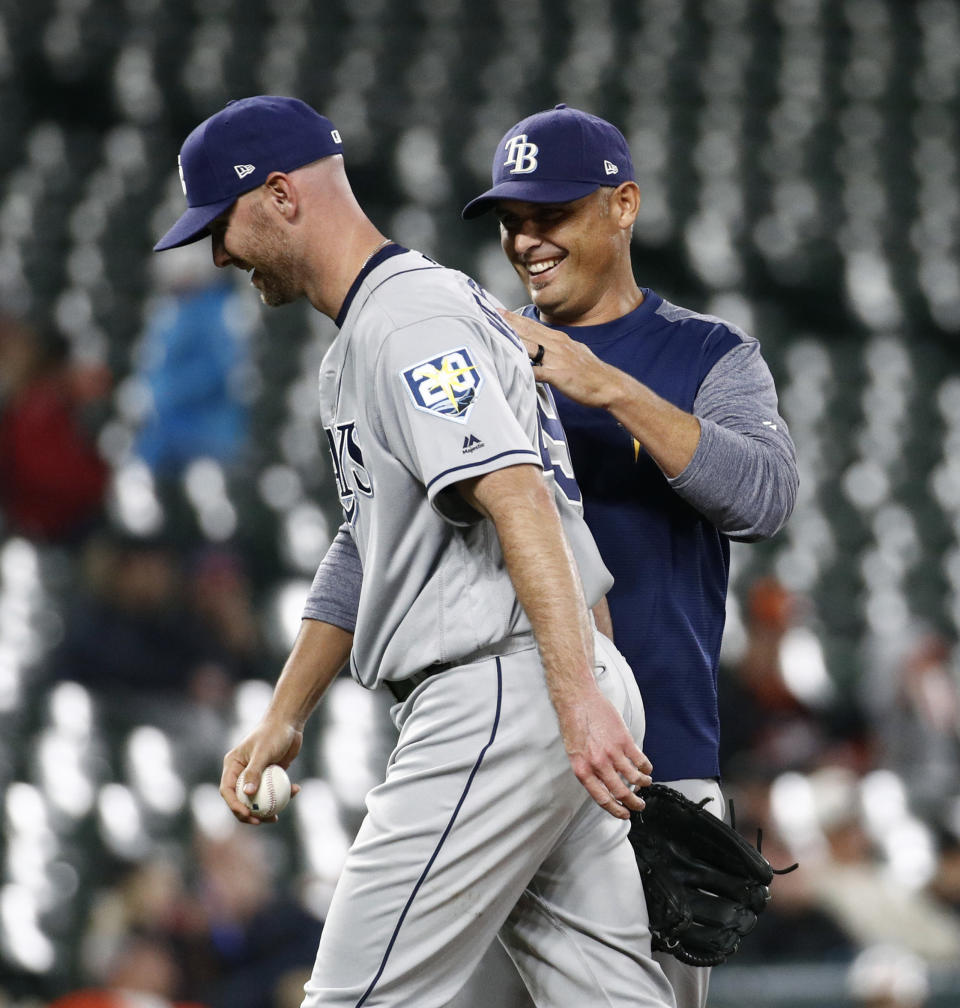 FILE - Tampa Bay Rays manager Kevin Cash, right, pats relief pitcher Jonny Venters on the back as he relieves Venters during the sixth inning of a baseball game against the Baltimore Orioles, Wednesday, April 25, 2018, in Baltimore. Pitchers can look to Jonny Venters as they return from a second operation to repair a torn elbow ligament: He made it back to the big leagues after what he calls 3 1/2 Tommy John procedures.(AP Photo/Patrick Semansky, File)