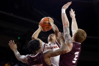 Southern California guard Boogie Ellis, center, shoots against Eastern Kentucky guards Russhard Cruickshank, left, and Cooper Robb during the first half of an NCAA college basketball game Tuesday, Dec. 7, 2021, in Los Angeles. (AP Photo/Ringo H.W. Chiu)