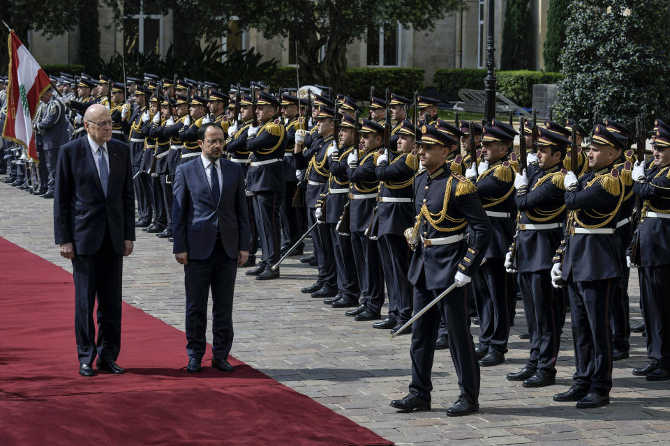 Cyprus' President Nikos Christodoulides, on carpet right, attends a military welcome ceremony with Lebanese caretaker Prime Minister Najib Mikati,on carpet left, upon his arrival to the government headquarters in Beirut, Lebanon, Monday, April 8, 2024. Christodoulides' visit to Beirut comes after he asked the European Union last week to intervene with Lebanese authorities to stop boatloads of Syrian refugees from heading to the east Mediterranean island nation. Lebanon's caretaker prime minister asked Southern European countries along the Mediterranean Sea to pressure the European Union to help Lebanon deport undocumented migrants. (AP Photo/Bilal Hussein)