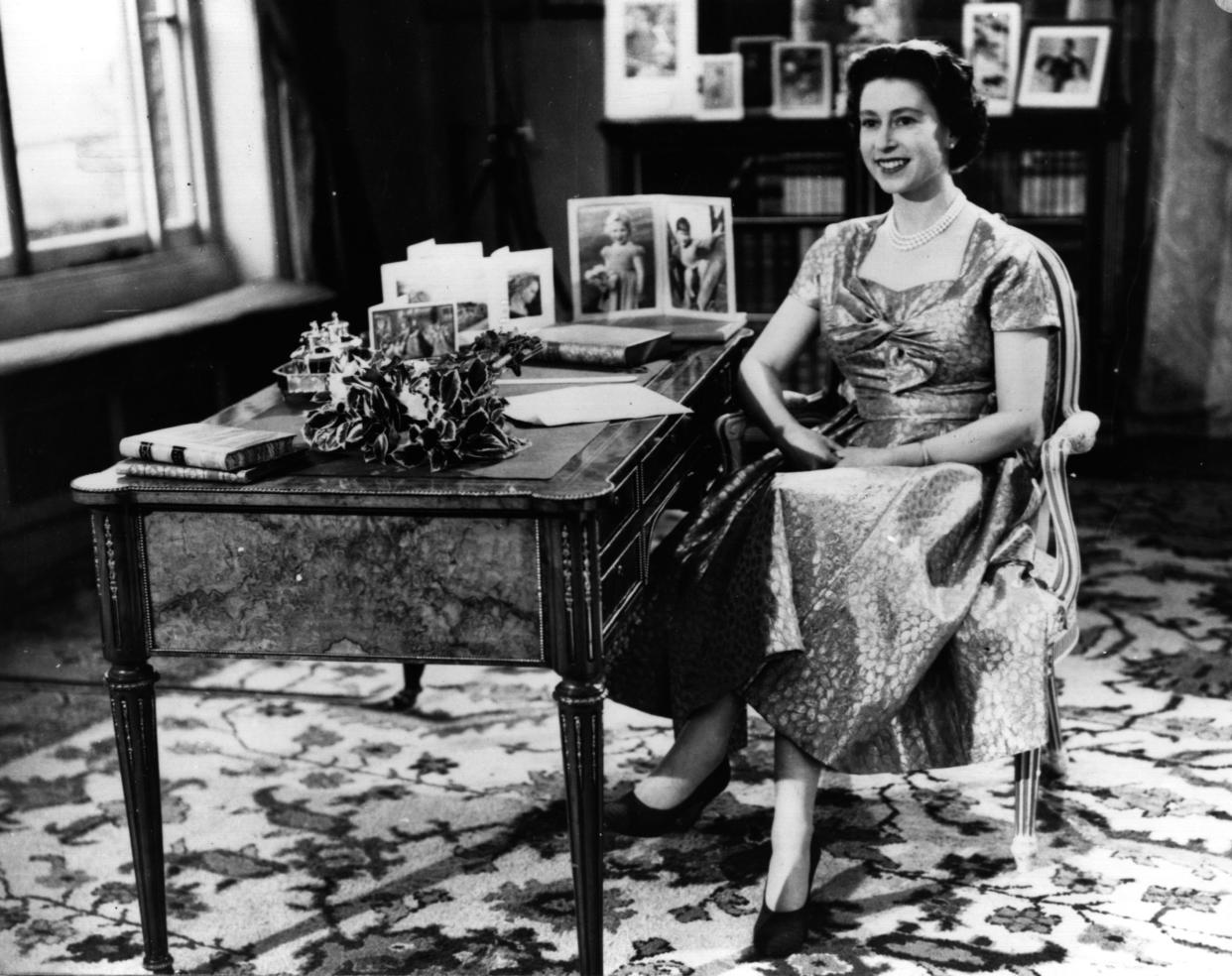 Queen Elizabeth II smiling towards The Prince Philip, Duke of Edinburgh just before the end of her first Christmas Day television speech to her nation.