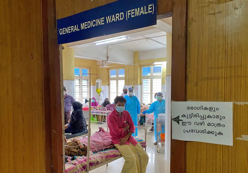 A man looks out from a COVID-19 ward in the Government Medical College Hospital in Manjeri