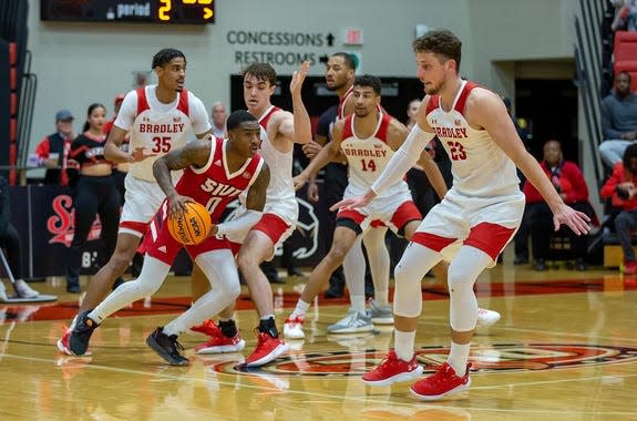 The Bradley defense (left-to-right) Darius Hannah, Connor Hickman, Malevy Leons and Ville Tahvanainen swarm around guard Damarco Minor during a 56-54 win over Southern Illinois University-Edwardsville at First Community Arena on Tuesday, Dec. 6, 2022.