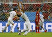 Chile's Gonzalo Jara celebrates a goal by his teammate Chile's Charles Aranguiz (not pictured) during their 2014 World Cup Group B soccer match against Spain at the Maracana stadium in Rio de Janeiro June 18, 2014. REUTERS/Pilar Olivares (BRAZIL - Tags: SOCCER SPORT WORLD CUP)