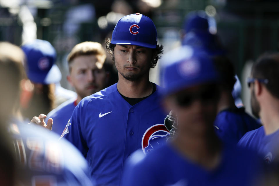 Chicago Cubs starting pitcher Yu Darvish is greeted in the dugout during the second inning of a spring training baseball game against the Milwaukee Brewers, Saturday, Feb. 29, 2020, in Mesa, Ariz. (AP Photo/Gregory Bull)