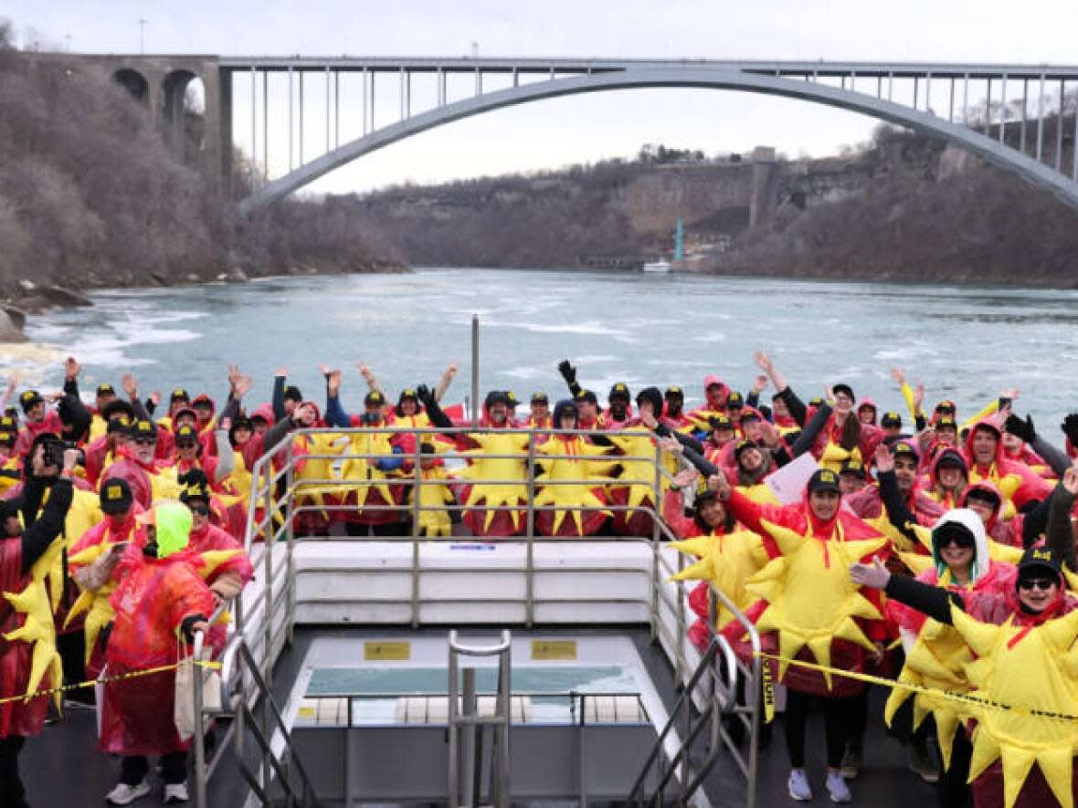 Hundreds of people dressed as the sun gathered on a boat in Niagara Falls, Ont.,  to set a new world record on April 8, 2024. (City of Niagara Falls - image credit)