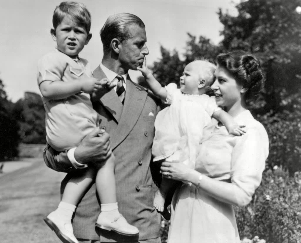 Queen Elizabeth II and the Duke of Edinburgh holding Prince Charles and Princess Anne, 1952 (Universal History Archive/Shutterstock)