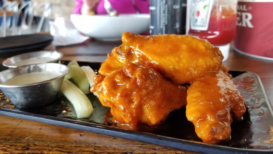 House Buffalo chicken wings, with sides of blue cheese and ranch, at Food + Beer’s Bradenton location.