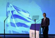 Greece's Prime Minister Kyriakos Mitsotakis delivers an annual state of the economy speech in the northern city of Thessaloniki, Greece, Saturday, Sept. 12, 2020. Mitsotakis outlined plans Saturday to upgrade the country's defense capabilities, including purchases of new fighter planes, frigates, helicopters and weapons systems, amid heightened tensions with neighboring Turkey over rights to resources in the eastern Mediterranean. (Giannis Moisiadis/InTime News via AP)