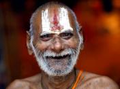 A Sadhu, or Hindu holy man, smiles into the camera on the banks of the River Ganges in Allahabad, India, Saturday, Sept. 12, 2009. (AP Photo/Rajesh Kumar Singh)