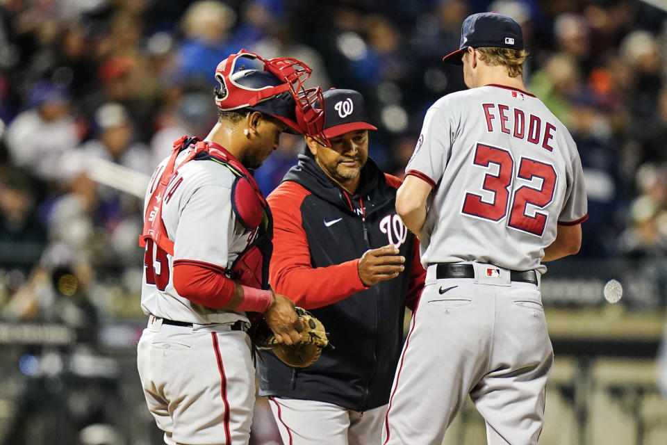 Washington Nationals manager Dave Martinez takes the ball from starting pitcher Erick Fedde (32) during the third inning of a baseball game against the New York Mets, Wednesday, Oct. 5, 2022, in New York. (AP Photo/Frank Franklin II)